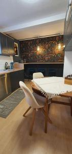 a dining room with a table and a kitchen at Geräumige Wohnungen Zentrumsnah Schwandorf in Schwandorf in Bayern +29 photos