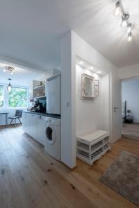 a white living room with a washer and dryer at TAMLiving Ljubljana 2BR Center 3 Bridges Great View Kitchen in Ljubljana