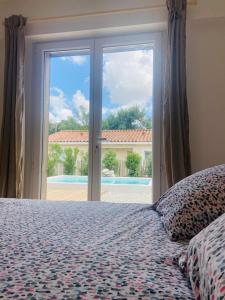 1 dormitorio con cama y ventana grande en Villa Gebano, en Saussines