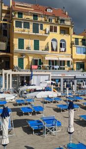 a bunch of beach chairs and umbrellas on a beach at Appartamenti sul mare Alassio in Alassio