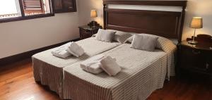 a bedroom with a large bed with two pillows on it at Casa Andrea in Las Palmas de Gran Canaria