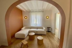 a living room with a white couch and a table at House with garden ideal D-DAY beaches and Caen in Hermanville-sur-Mer