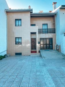 a large house with a brick driveway in front of it at Casa Riamar in São Jacinto