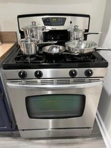 a stove with pots and pans on top of it at Cozy Home located in a prime area. in Philadelphia
