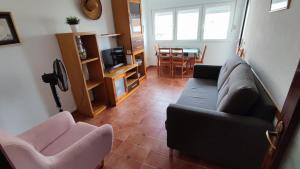 a living room with a couch and two chairs at El Mirador de Cadiz in Cádiz