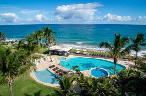 an aerial view of a resort pool and the ocean at Seawinds Penthouse Studio with Rooftop in Cabarete