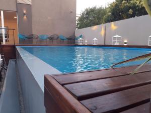 a large swimming pool with chairs in a building at DFC Salta Estudio 2p in Salta