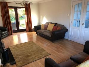 a living room with a couch and a table at Central House 5 Bedroom Luxury Stone Built House 