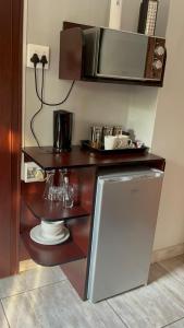 eine Küche mit einem Kühlschrank und einer Mikrowelle in der Unterkunft Silken Trap Accommodation NO LOADSHEDDING in Johannesburg