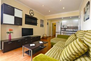 a living room with a couch and a tv at Apartment Vasco de Gama in Telde