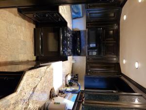 a kitchen with black cabinets and a counter top at Eagle's Nest in Big Bear Lake