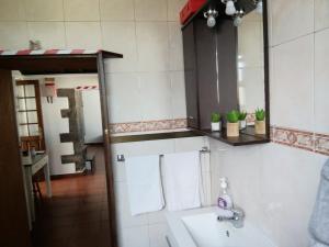 a bathroom with a sink and a mirror at Casa Dos Mosteiros in Mosteiros +37 photos