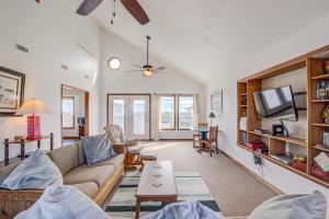 a living room with a couch and a tv at Whaley Topsail Beach in Topsail Beach