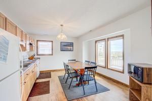 a kitchen with a table and chairs in it at Whaley Topsail Beach in Topsail Beach