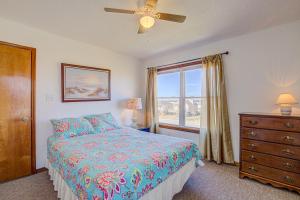 a bedroom with a bed and a dresser and a window at Whaley Topsail Beach in Topsail Beach