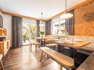 a dining room with wooden tables and chairs at Arenablick in Zell am Ziller