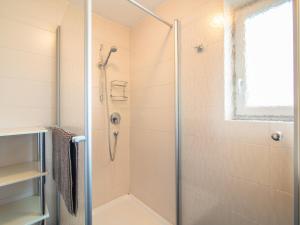 a bathroom with a shower with a glass door at Arenablick in Zell am Ziller