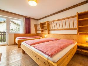 a bedroom with two bunk beds and a window at Arenablick in Zell am Ziller