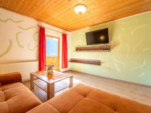 a living room with a couch and a tv at Apartment Schragl in Zell am Ziller