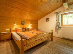 a bedroom with a large wooden bed in a room at Apartment Schragl in Zell am Ziller