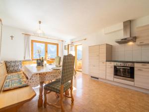 a kitchen with a table and chairs in a room at Apartment Schragl in Zell am Ziller