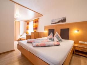 a bedroom with two beds with pillows on it at Haus Hauser in Tobadill