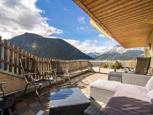 a balcony with chairs and a view of mountains at Haus Hauser in Tobadill