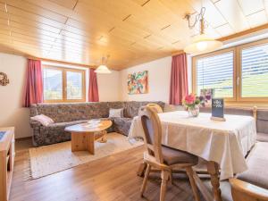 a living room with a table and a couch at Schallert in Bürserberg