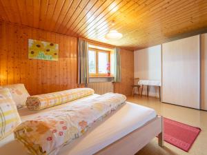 a bedroom with a bed with a wooden ceiling at Schallert in Bürserberg