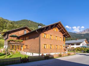 a large brown brick house with a roof at Landhaus Barbara in Silbertal