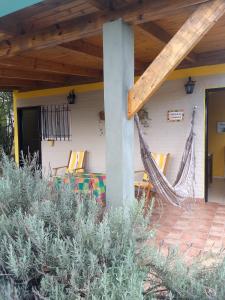una hamaca en el porche de una casa en Cabaña Refugio De Caminantes in 
