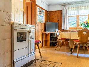 a kitchen and dining room with a table and chairs at Landhaus Barbara in Silbertal