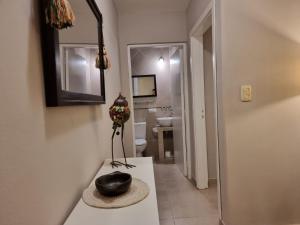 a black vase sitting on a counter in a bathroom at Marfil in Posadas
