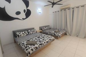 a bedroom with two beds and a panda sign on the wall at Netflix High Speed Internet 9pax Cinema Theme house Setiawalk with pool in Puchong