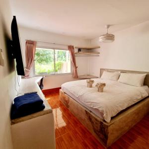 Un dormitorio con una cama con dos ositos de peluche. en Filou Studio Golf Pool Access 29 67 en Ko Chang