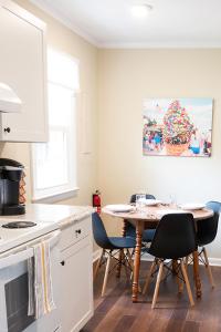 a kitchen with a table and chairs and a kitchen with a table and a painting at Adorable 2-bedroom bungalow near Easton, Denton in Denton