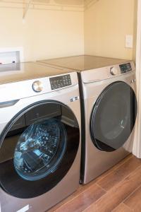 a washing machine and a washer in a kitchen at Adorable 2-bedroom bungalow near Easton, Denton in Denton