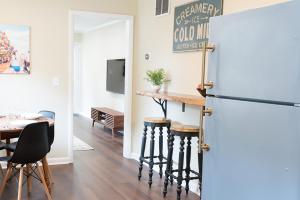 a kitchen and dining room with a bar and a refrigerator at Adorable 2-bedroom bungalow near Easton, Denton in Denton