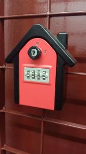 uma caixa de correio vermelha está ligada a uma parede de tijolos em Snoopy homestay Two Bedroom em Batu Pahat