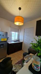 a room with a kitchen with a table and a light at Boquete destiny in Boquete