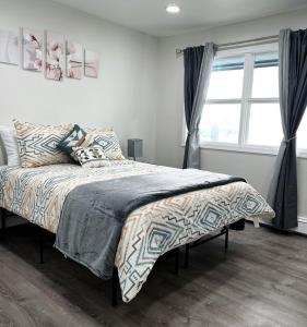 a bedroom with a bed and a large window at Anchorage midtown apartment-Wyoming 2 in Anchorage