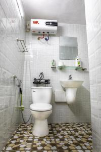 a bathroom with a toilet and a sink at VietnamTravel in Thái Nguyên