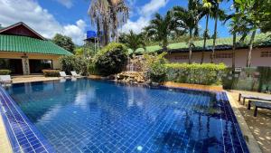 a swimming pool in front of a house at Garden Resort in Ko Chang