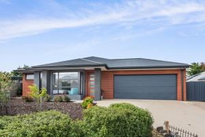 a brick house with a garage at Beach Life in Indented Head