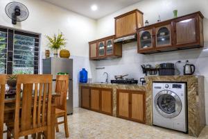 a kitchen with a washer and dryer in a room at VietnamTravel in Thái Nguyên