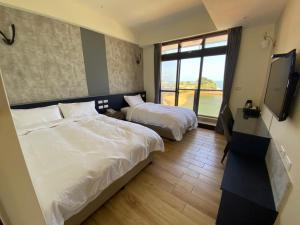 Postel nebo postele na pokoji v ubytování Zhuluowan Club
