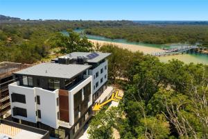 an aerial view of a building next to a river at Nineteen On Gregory G02 in South West Rocks