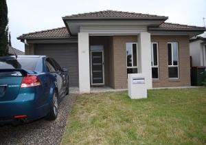 a blue car parked in front of a house at The Summer Lakeside Room in North Lakes