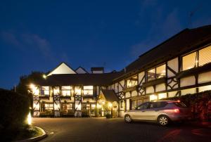 a car parked in front of a building at night at The Surrey Hotel in Auckland