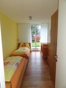 a bedroom with two beds and a window at Chasa Felix Scuol in Scuol